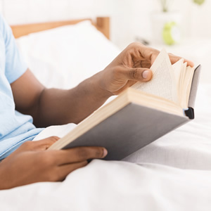 Student studying in bed with electric blanket 
